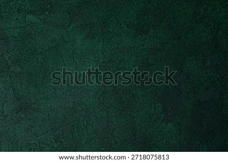 Green textured grunge wall with dark aged plaster and rough surface