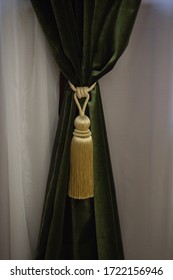 green thick curtain with gold tassels