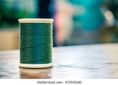Green thread on the table with blurry background