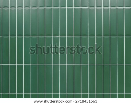 Green tile wall background with clean geometric pattern. Ceramic surface design suitable for interior, bathroom, kitchen, architecture, and decorative concepts.