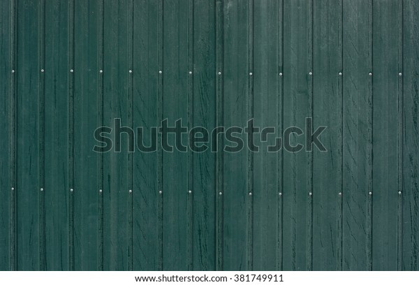 green tin fence with\
rivets