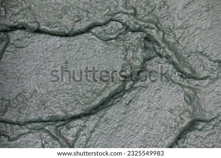 green tone texture of rough cement plastering traces of cement The kura is uneven forming a beautiful pattern by zooming in on the lens to see the details It is  beautiful background light from nature