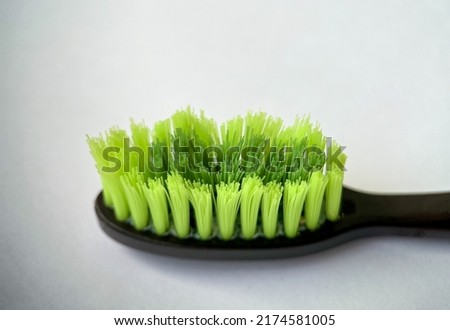 Green toothbrush bristles close up in macro