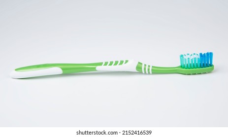 Green Toothbrush For Teeth On The White Background