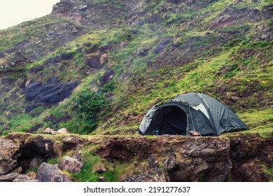 Green Tourist Tent In A Rough Mountain Area. Cool Morning Mood. Camping Area. Outdoor Holiday In A Nature Area.