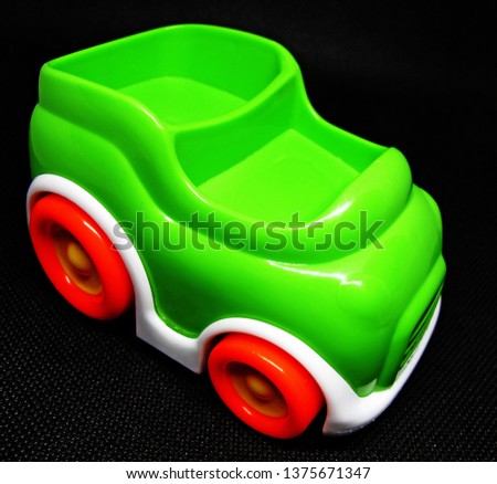 green toy car on black background             