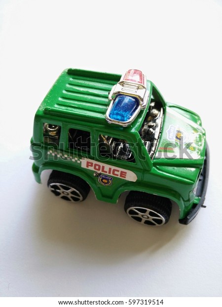 green toy police car\
on white background