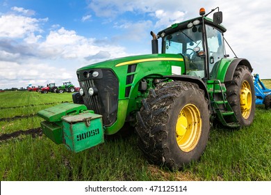 Green Tractor With Big Wheels In The Field