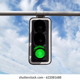 Green traffic light against blue sky background with Clipping Path