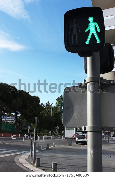 The green traffic light allowing pedestrian\
traffic. Pedestrian crossing in the city of Nice, France. Not far\
from the Vauban stop.