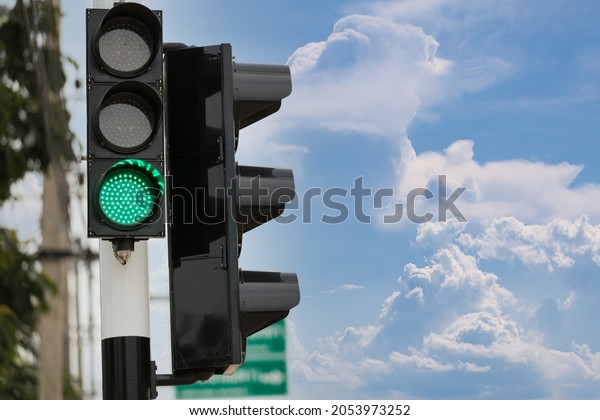 Green traffic light up in city. Green color on the\
traffic light.