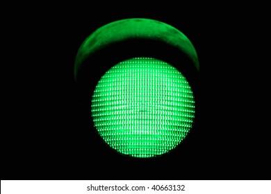 green traffic light, isolated on black background