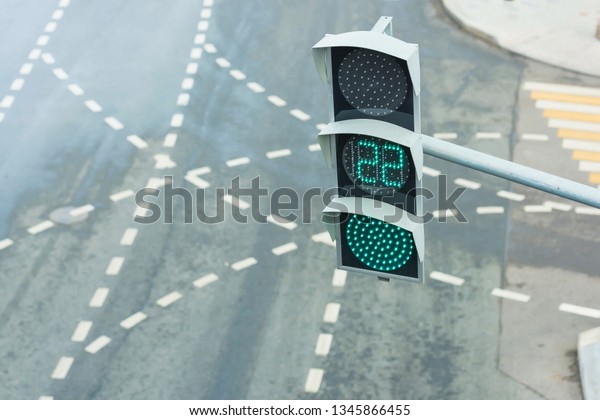 Green traffic light. Modern\
traffic lights with a timer. Road traffic in the big city. Road\
markings at a regulated intersection. Pedestrian crossing in the\
metropolis