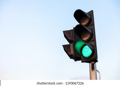 Green Traffic Light On Blue Sky Background.