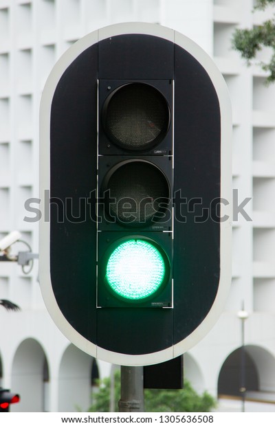 Green traffic light on city highway road close up.\
Traffic light on urban\
street