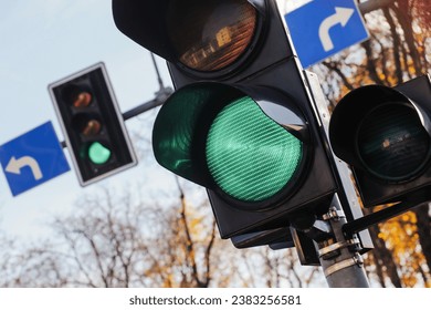 Green traffic light signal. Left and right intersection. Permission to drive. Smart traffic light. City crossing with semaphore. - Powered by Shutterstock