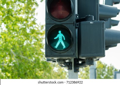 Green Traffic Light Signal For Pedestrians On The Street Crosswalk