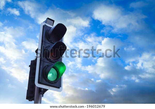 Green\
Traffic Light with sky, business freedom concept\
