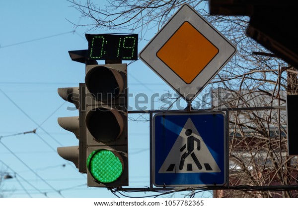 green traffic lights and\
road signs
