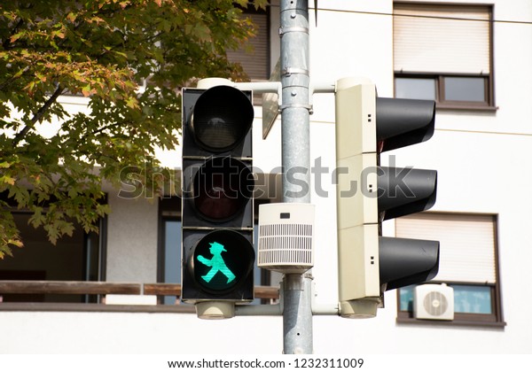 Green traffic lights signals with traffic road on\
Sandhausen street at Heidelberg-Kirchheim district village in\
Heidelberg, Germany 