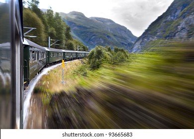 Green Train Moving In The Mountains. Norway.