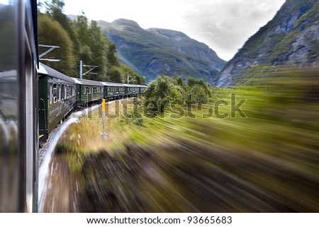 Green train moving in the mountains. Norway.