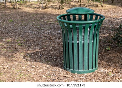 A Green Trash Can In The Park