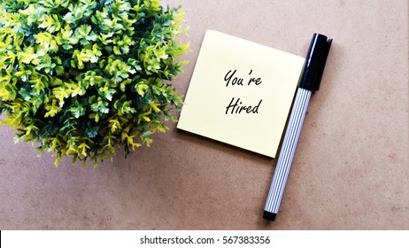 Green tree, sticky note with text You're Hired