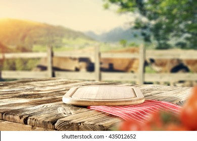 Green Trees And Farm And Shabby Wooden Table And Red Napkin And Red Vegetables 