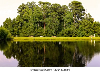 Green Trees and a pond reflection at Seagrove Park Apex North Carolina - Shutterstock ID 2014618664