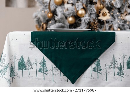 Green triangle table runner on forest print Christmas tablecloth
