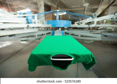 Green t-shirt silk screen printing machine, look of the mock up tshirt before printing process, horizontal image 