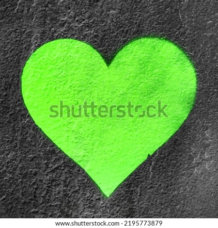 Green urban heart. Fluo love heart hand drawn on grungy wall. Textured background trendy street style.