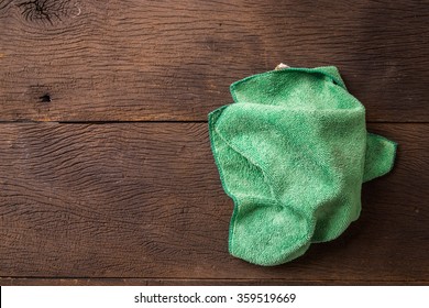 Green Used Cleaning Rag On Wood Table.