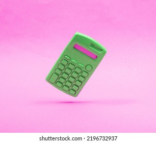 Green vcalculator levitation on pink background