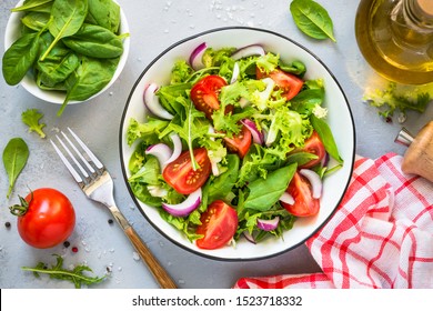 Green Vegan Salad From Green Leaves Mix And Vegetables. Top View On Gray Stone Table.