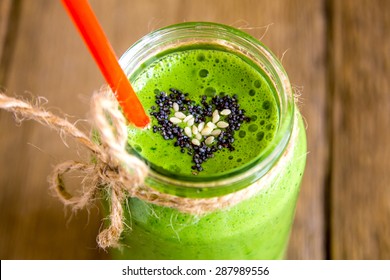 Green Vegetable And Herbs Smoothie With Heart Of Poppy And Sesame Seeds. Love For A Healthy Raw Food Concept.