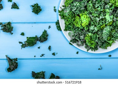Green vegetable, leaves of kale from above on white plate, vegetarian food concept