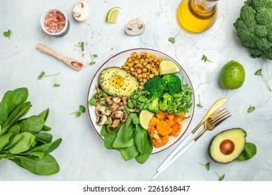 Green vegetable vegan salad with avocado, mushrooms, broccoli, spinach, chickpeas, pumpkin. Healthy vegetarian food concept. top view. - Powered by Shutterstock