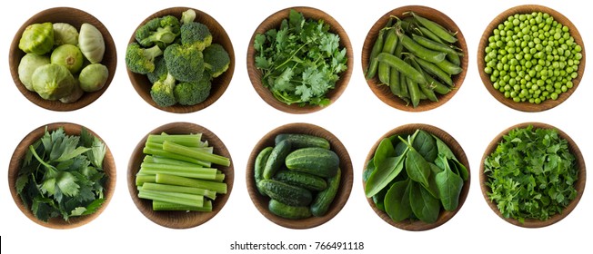 Green Vegetables And Herbs Isolated On A White Background. Squash, Brocoli, Green Peas, Cucumbers And Leaves Parsley, Celery, Cilantro, Spinach In Wooden Bowl With Copy Space For Text. Top View. 