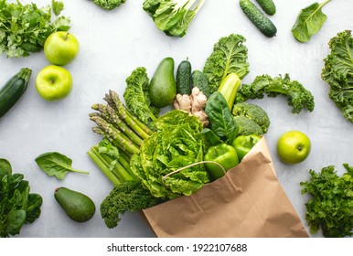 Green vegetables in a paper shopping bag, top-down view, sustainable living concept - Powered by Shutterstock