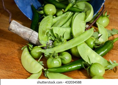 Green vegetables and small vintage bucket image, still-life flash photography
