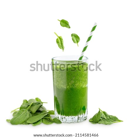 Green vegetarian fitness smoothie made of raw spinach leaves which are source of vitamins and dietary fiber used for healthy vegan dieting and weight loss served in glass with straw isolated on white