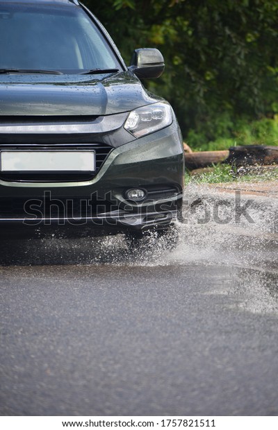 A\
green vehicle splashing the water and moving fast \
