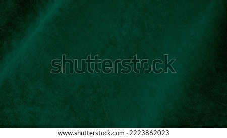 Green velvet fabric texture used as background. Empty green fabric background of soft and smooth textile material. There is space for text.