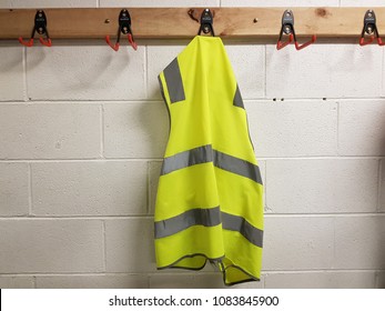 Green vest hangs on the wall.