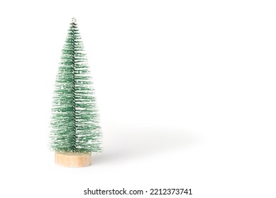 Green Vintage Bottle Brush Christmas Tree On A White Background.  Miniature Christmas Tree In The Shape Of A Triangular Brush On A Wooden Round Stand. Front View. Copy Space For Holiday Text.