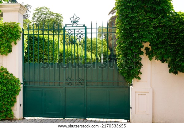 green vintage house gate and garage door to access\
home garden