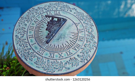 A Green Vintage Sun Dial Or Sun Clock Above Swimming Pool. 