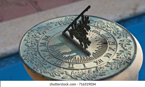 A Green Vintage Sun Dial Or Sun Clock Above Swimming Pool. 